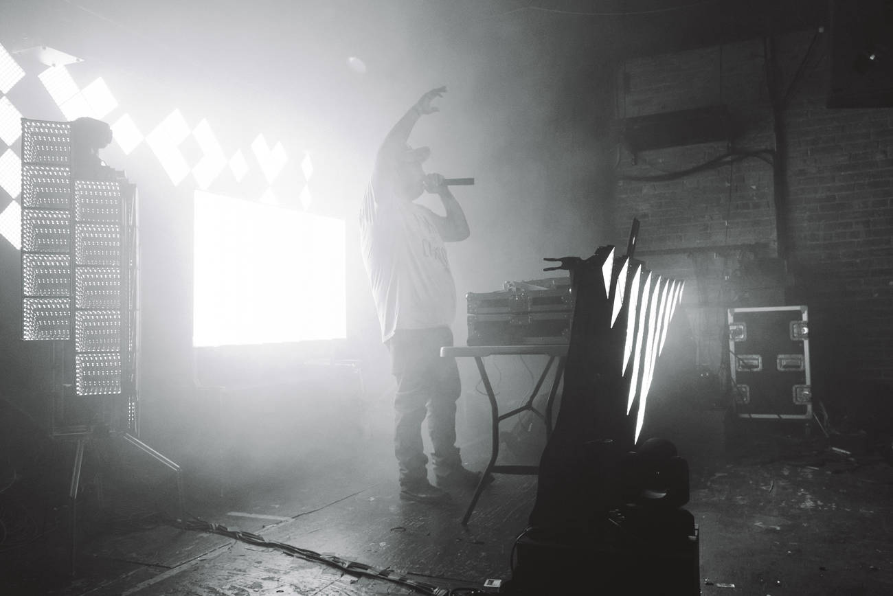 DJ hand in the air talking to crowd
