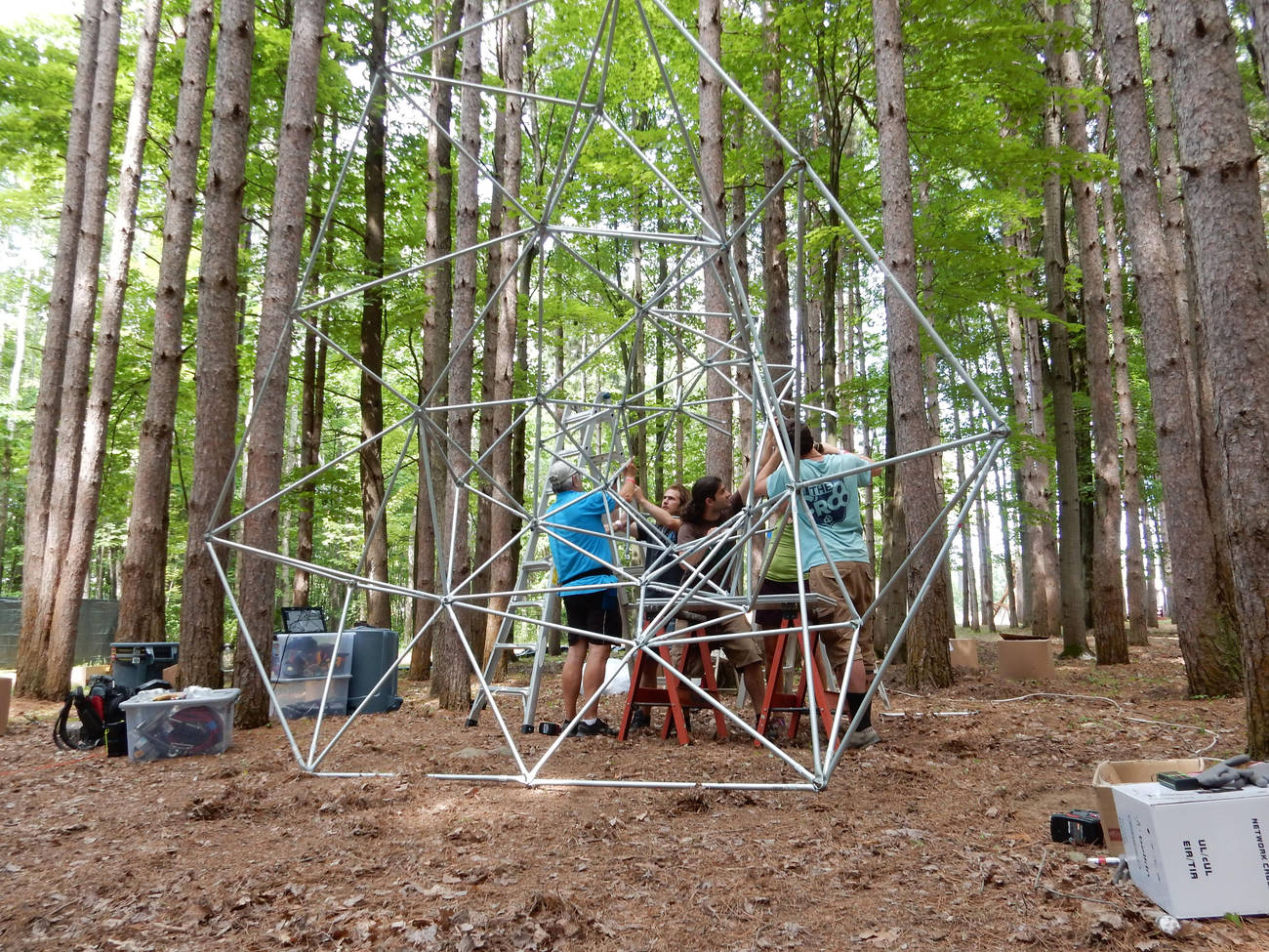 Electric Forest crew hoisting Event Horizon upright