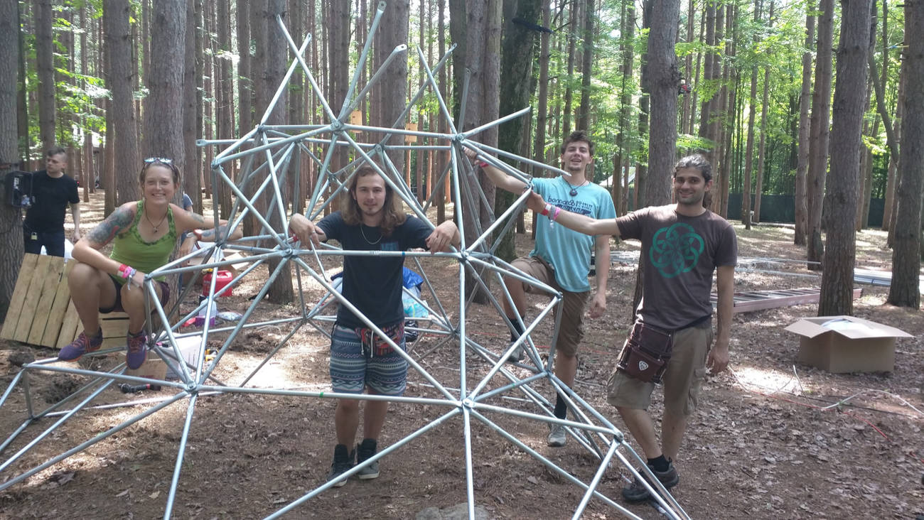 the Electric Forest crew posing for a photo with Event Horizon half way built